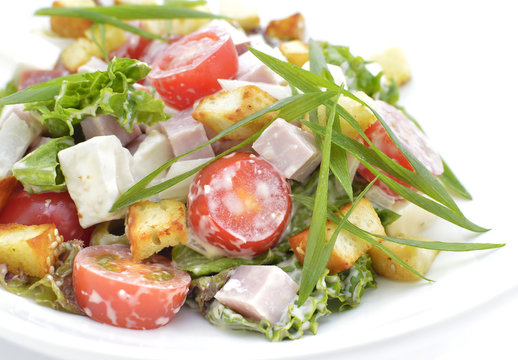 Salat with ham and vegetables on white