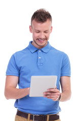 happy casual young man with his tablet