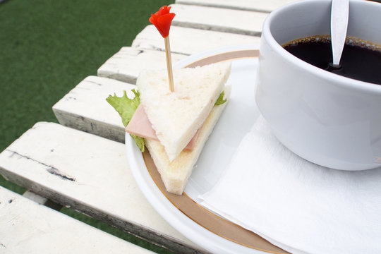 Coffee break and sandwich on a table