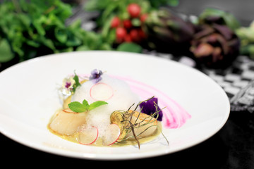 scallops over artichoke's cream with flower garnish and ingredie