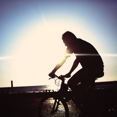 Man on bicycle riding at a coastline