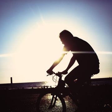Man on bicycle riding at a coastline © dariazu