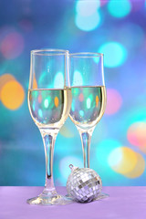Two champagne glasses on colorful background