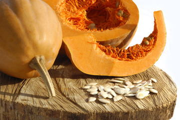 Pumpkins and Pumpkins seeds on wood and white background
