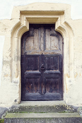 Fototapeta na wymiar old wood door with metal knob in Prejmer fortified church, Braso
