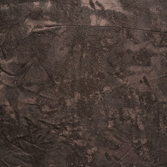 Creased brown cloth material fragment