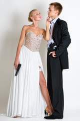 beautiful spy couple in evening dress with a guns.