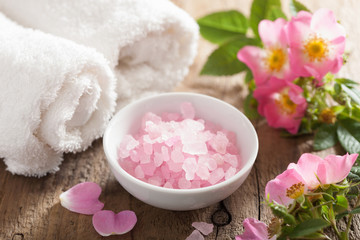 Obraz na płótnie Canvas spa with pink herbal salt and wild rose flowers