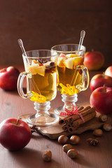 glass of mulled apple cider with orange and spices, winter drink