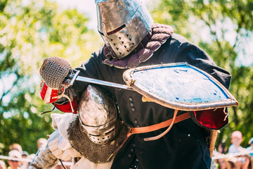 Knights In Fight With Sword. Restoration Of Knightly Battle