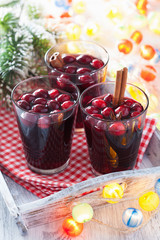 glass of mulled wine with cranberry and spices, winter drink