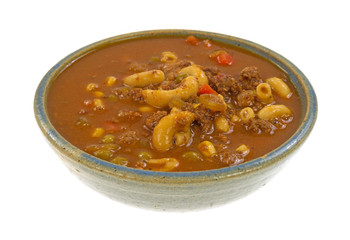 Cooked hamburger soup in an old stoneware bowl