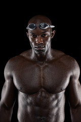 Fototapeta na wymiar Professional male swimmer on black background