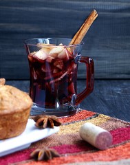 cup of hot Christmas mulled wine with cake