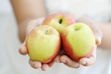 Woman holding apple.