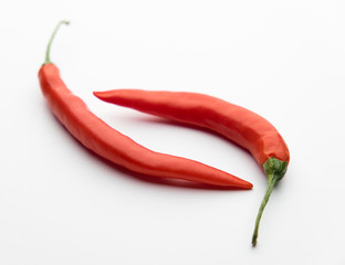 Red chili pepper on a white table.