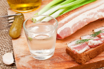 glass of vodka, cucumber and bacon