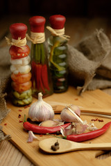 Onions, garlic and chili on a wooden table.