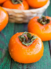 ripe persimmons in a wicker basket