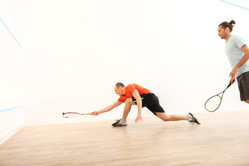 Two men playing match of squash.
