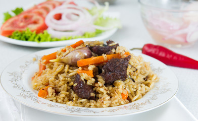 National pilau rice with beef served on a round plate