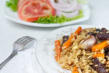National pilau rice with beef served on a round plate