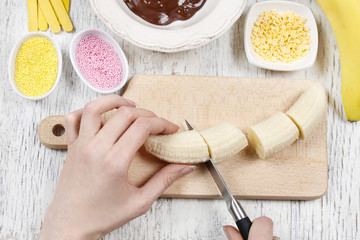 Fototapeta na wymiar How to make chocolate dipped bananas - step by step, tutorial