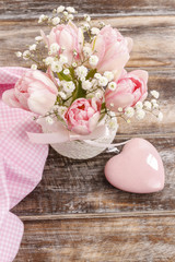 Obraz na płótnie Canvas Romantic bouquet of pink tulips and gypsophilia paniculata