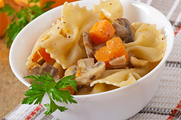 Pasta in cream sauce with slices of pumpkin and mushroom