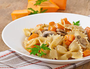 Pasta in cream sauce with slices of pumpkin and mushroom