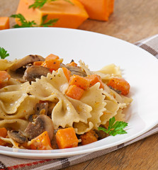 Pasta in cream sauce with slices of pumpkin and mushroom