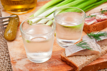 Two glasses of vodka and a snack
