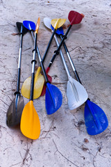 Pile of Paddles on Beach