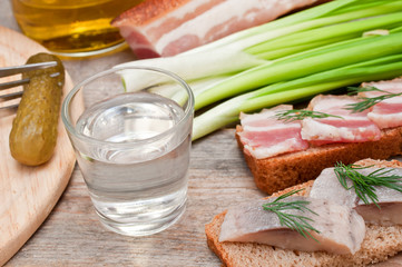 Vodka, green onion, cucumber and bacon sandwiches and herring