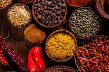 Variability of Asian spices on wooden table