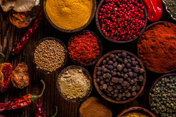 Variability of Asian spices on wooden table