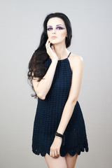 Portrait of a beautiful young woman on a gray background