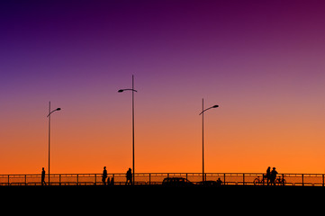 Fototapeta premium People on the bridge in sunset