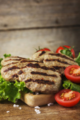Grilled beef meatballs and vegetables on wooden bord