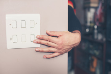 Man switching on lights
