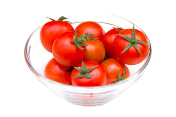 Tomato on glass bowl on white background