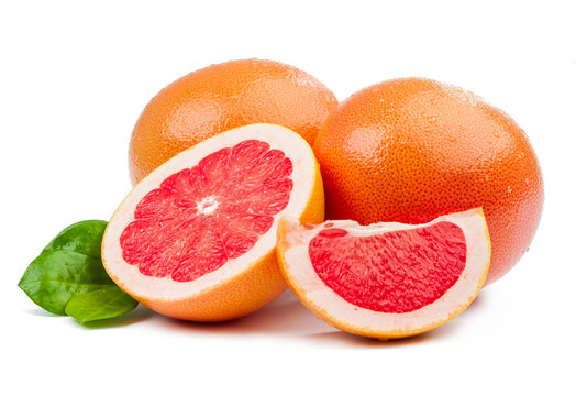 Two grapefruit and slices with leaves isolated