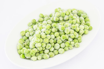 Frozen peas in isolate on white.