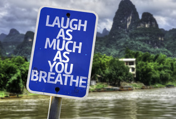 Laugh As Much As You Breathe sign with a exotic background