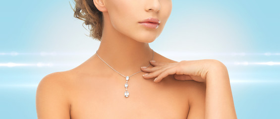 woman wearing shiny diamond pendant