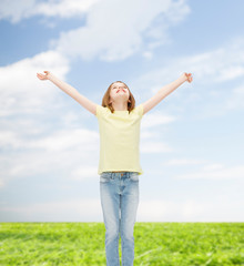 smiling teenage girl with raised hands