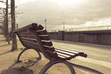 Empty romantic sunny bench at boardwalk in Düsseldorf Germany