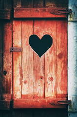 Old vintage toilet door with a heart shaped hole