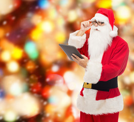 man in costume of santa claus with tablet pc