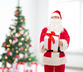 man in costume of santa claus with gift box